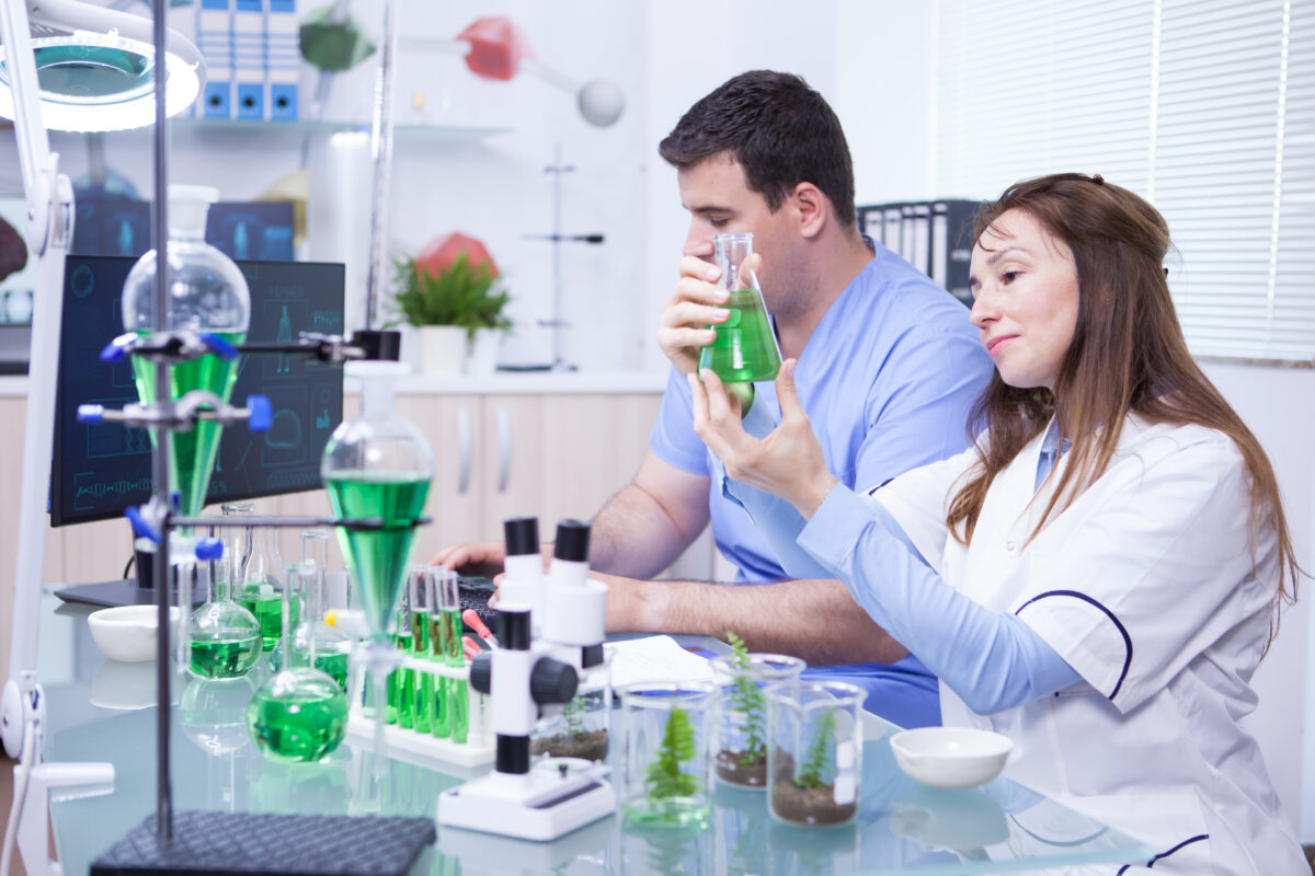 Middle age woman with her assistant working in a research lab for microbiology